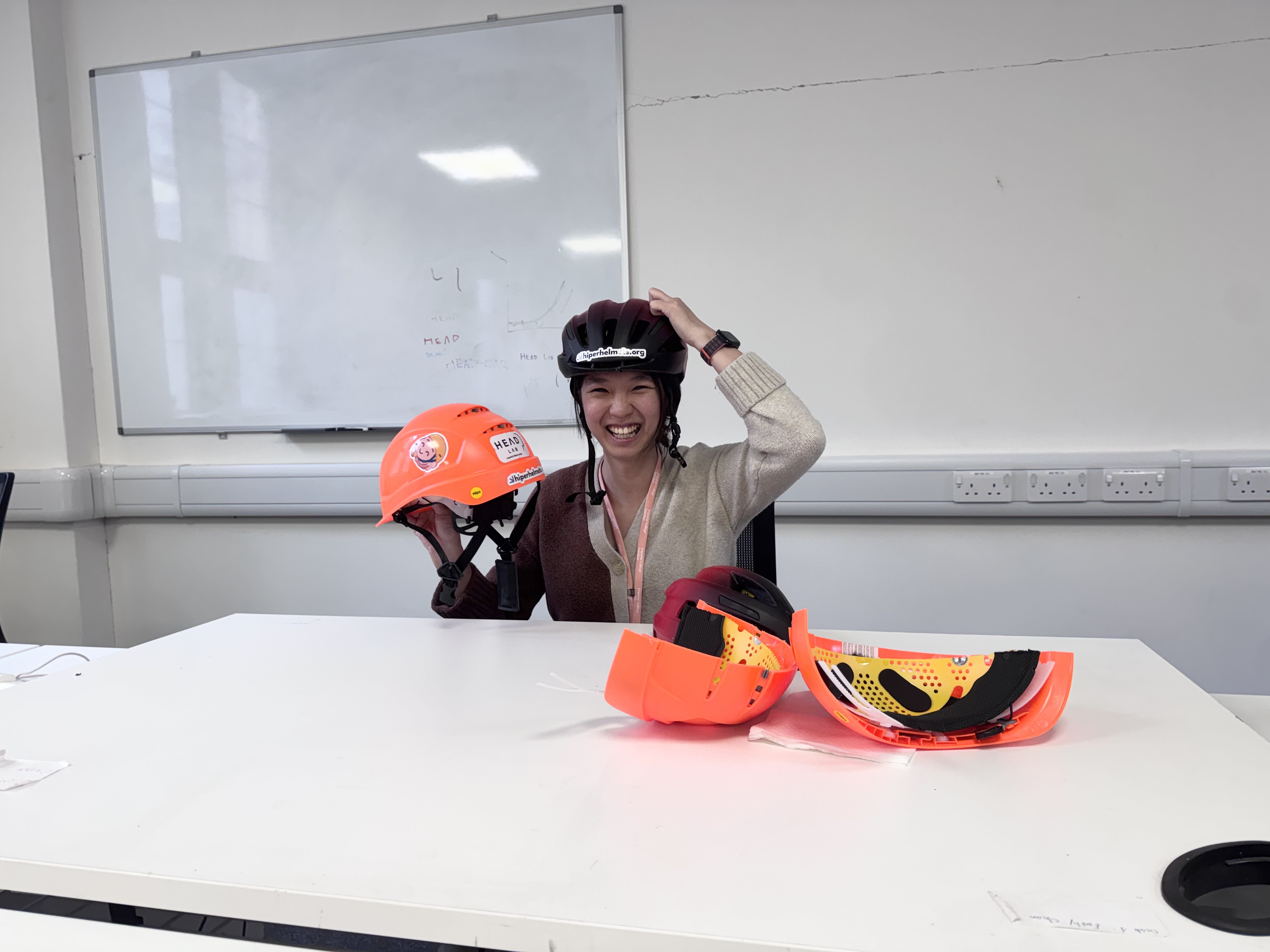 Me at my desk with helmets